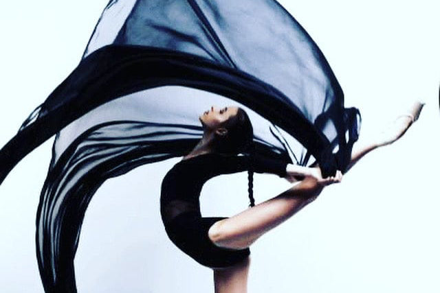 Woman in a stylish white dress walking on a Laguna Beach shoreline